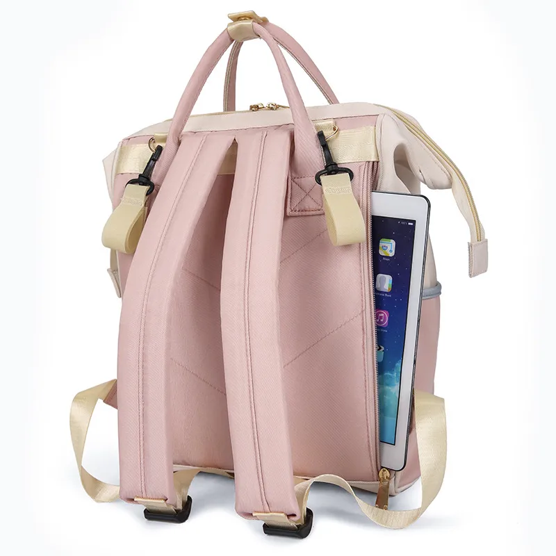 背面のファスナー付きポケットにタブレットが収納されている、ピンクとベージュのリュック。